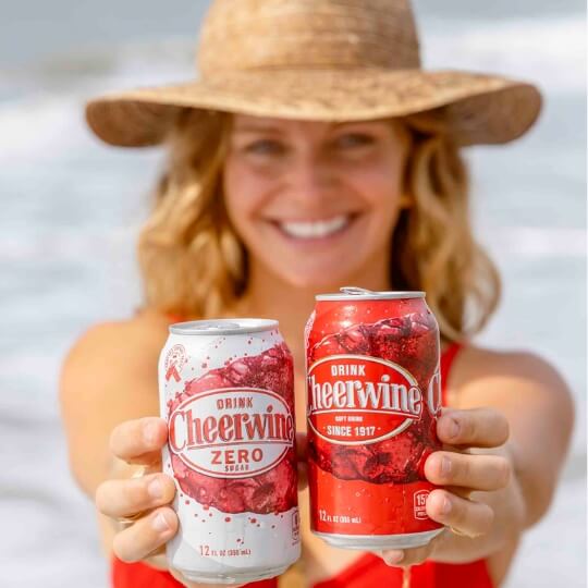 Q32026-left woman in sun hat holding Cheerwine Zero Sugar and Cheerwine cans